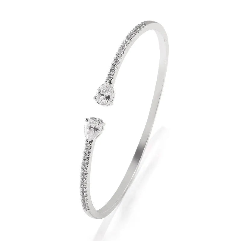 Close-up of a multi-zircon inlay fashion bracelet in copper, shown in blue and white colour options.