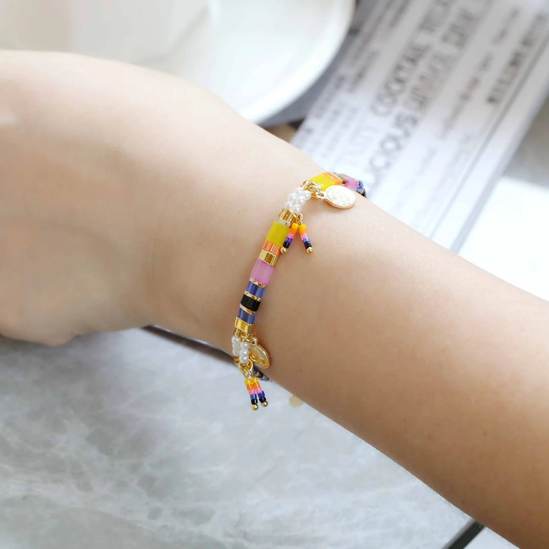 Women's handcrafted bracelet with imitation pearl and coloured glass beads in one of six colour styles.