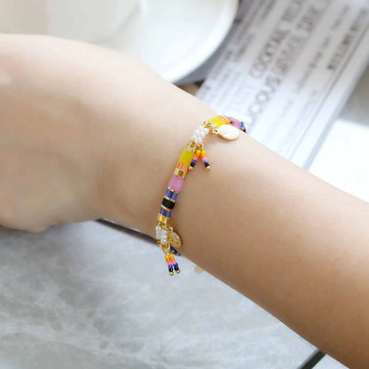Women's handcrafted bracelet with imitation pearl and coloured glass beads in one of six colour styles.
