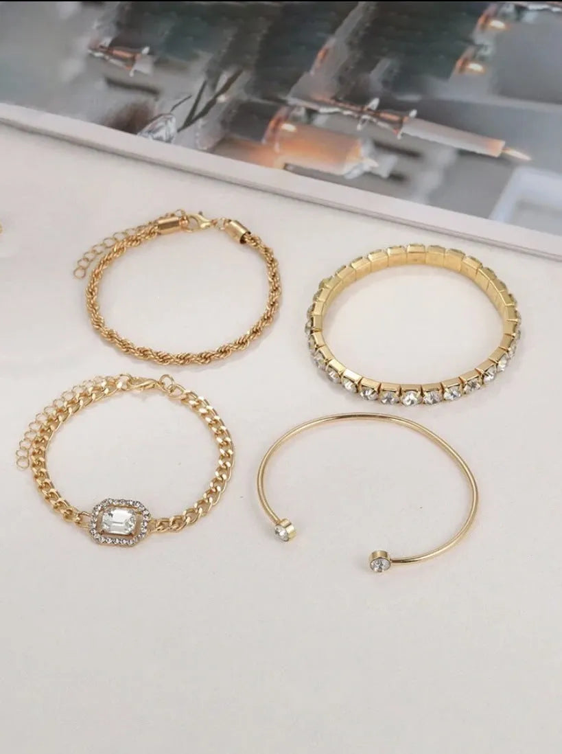 Women's four-piece alloy jewellery set with geometric square diamond shapes and chain links in gold finish