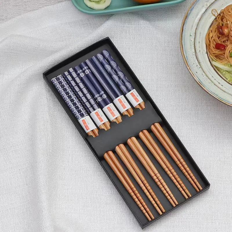 Set of five pairs of bamboo chopsticks showing lucky cat and chi ya blue pattern designs in gift box.