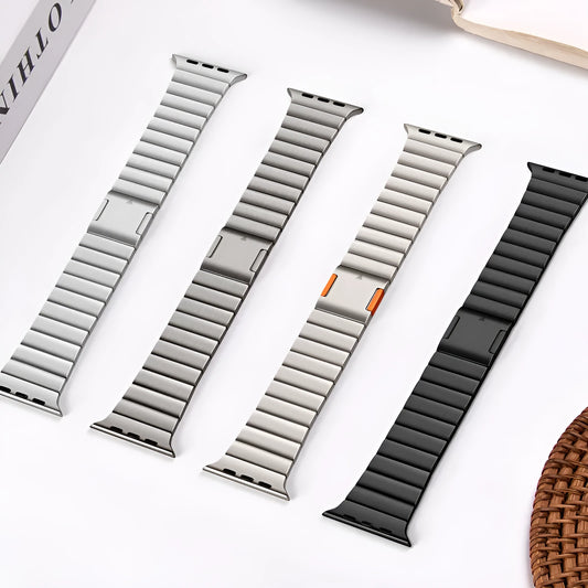 Silver stainless steel magnetic buckle strap attached to an Apple Watch on a wrist.