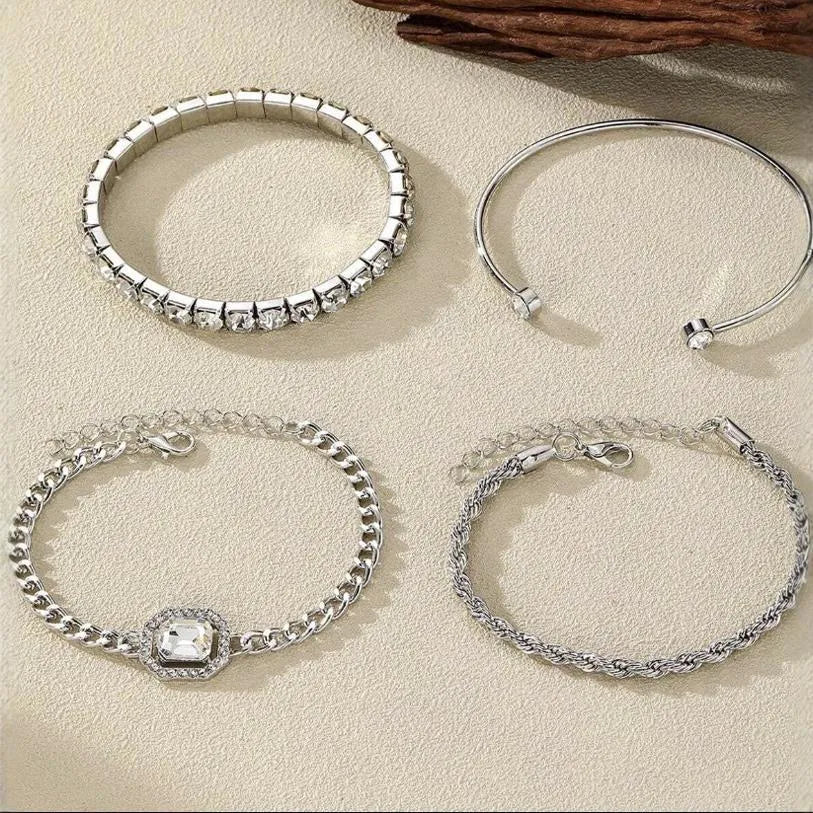 Women's four-piece alloy jewellery set with geometric square diamond shapes and chain links in gold finish