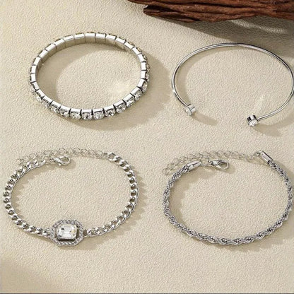 Women's four-piece alloy jewellery set with geometric square diamond shapes and chain links in gold finish