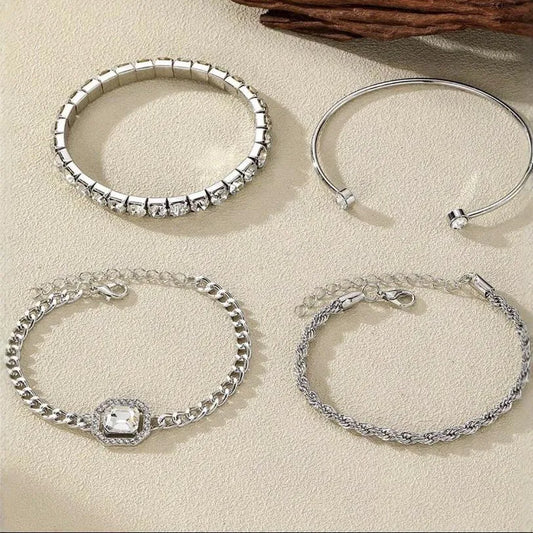 Women's four-piece alloy jewellery set with geometric square diamond shapes and chain links in gold finish