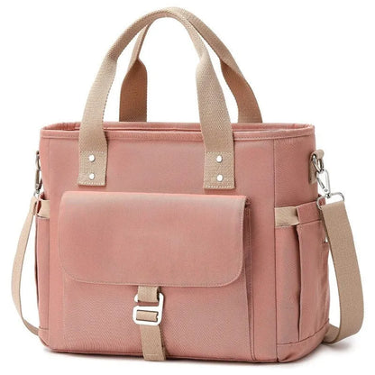 Insulated cube-shaped picnic bag with a removable shoulder strap in pink, shown with a side pocket.
