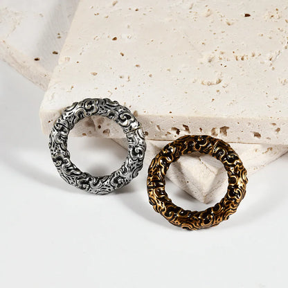A pair of stainless steel fashion earrings featuring a totem pattern design in an electroplated colour.