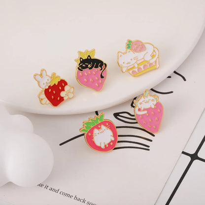 Close-up of a cute cat strawberry and dripping cake oil design metal alloy brooch pin.