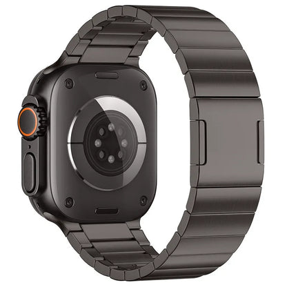 Silver stainless steel magnetic buckle strap attached to an Apple Watch on a wrist.