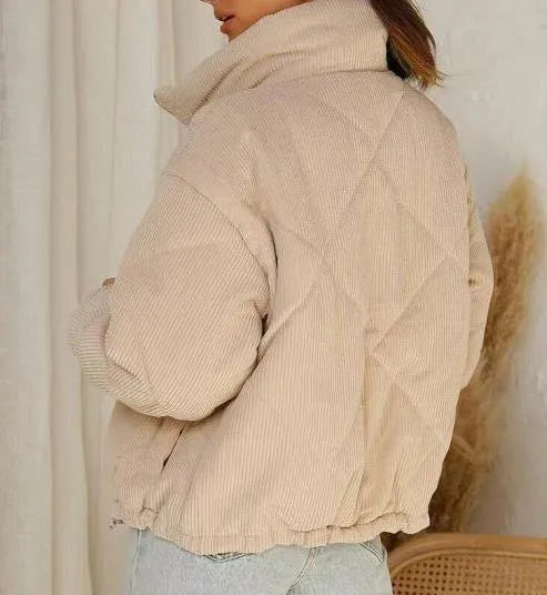 Apricot women's corduroy zip-up jacket with a stand collar and long sleeves on a hanger.