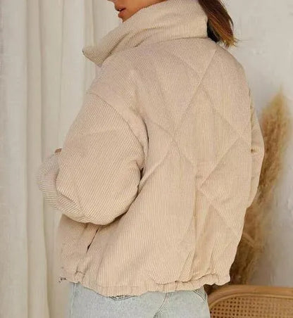 Apricot women's corduroy zip-up jacket with a stand collar and long sleeves on a hanger.