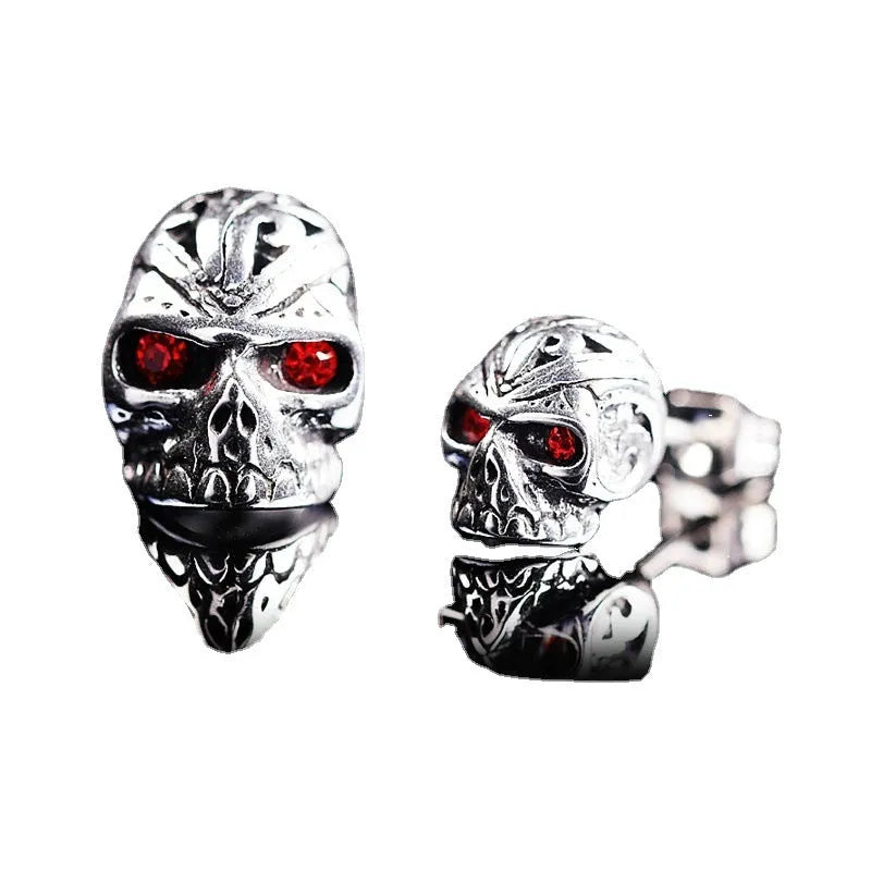 Red eye skull stud earrings with electroplated alloy construction and gemstone accents