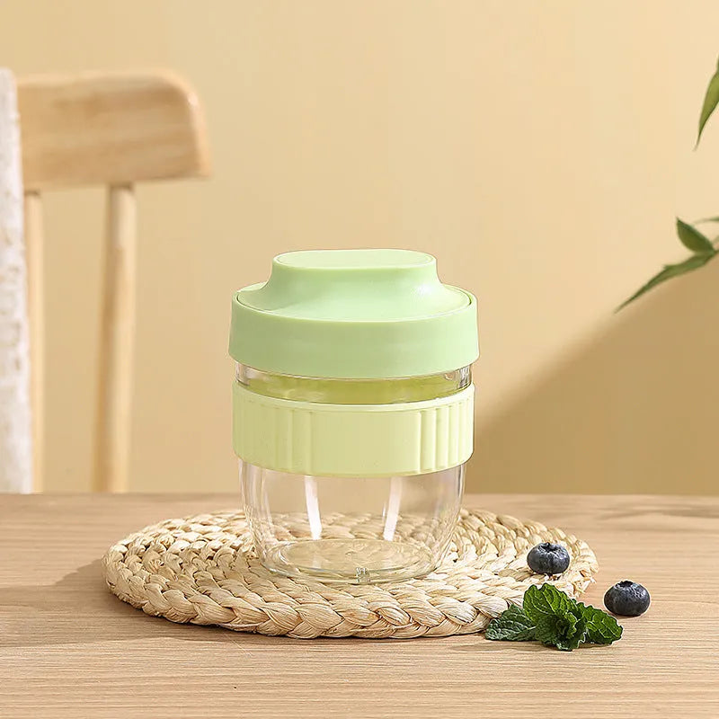 Green PP plastic salad cup with attached lid and spoon on a white background.
