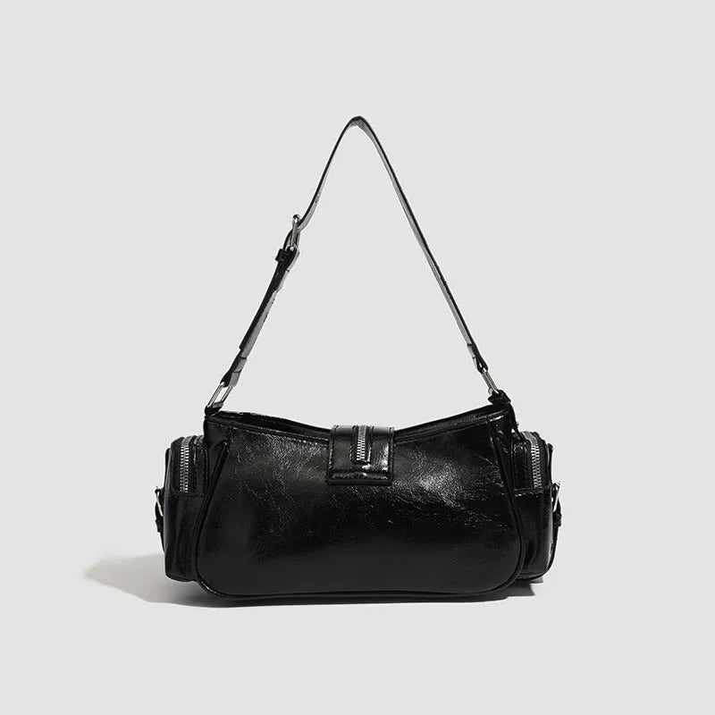 Black dumpling-shaped retro women's shoulder bag with a front pocket and organiser interior.