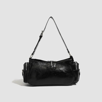 Black dumpling-shaped retro women's shoulder bag with a front pocket and organiser interior.