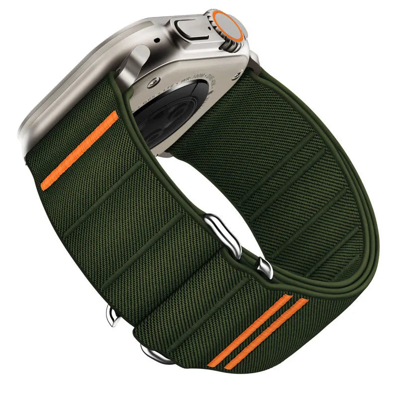 Elastic nylon Apple Watch band in Army Green with stainless steel buckle, shown on a wrist.