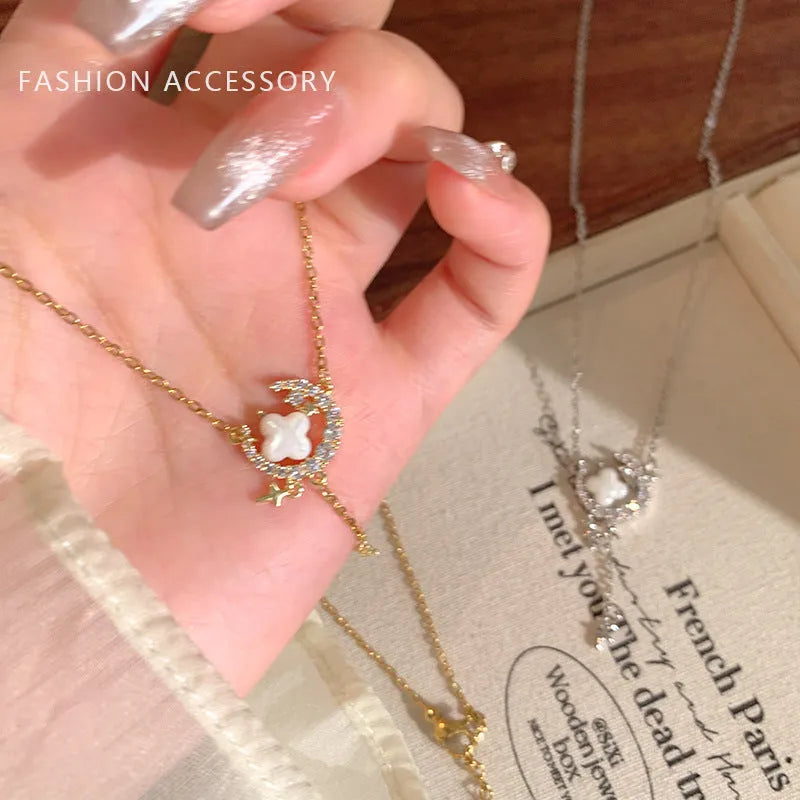 Women's sparking zirconium necklace showing star and moon pendant on adjustable chain