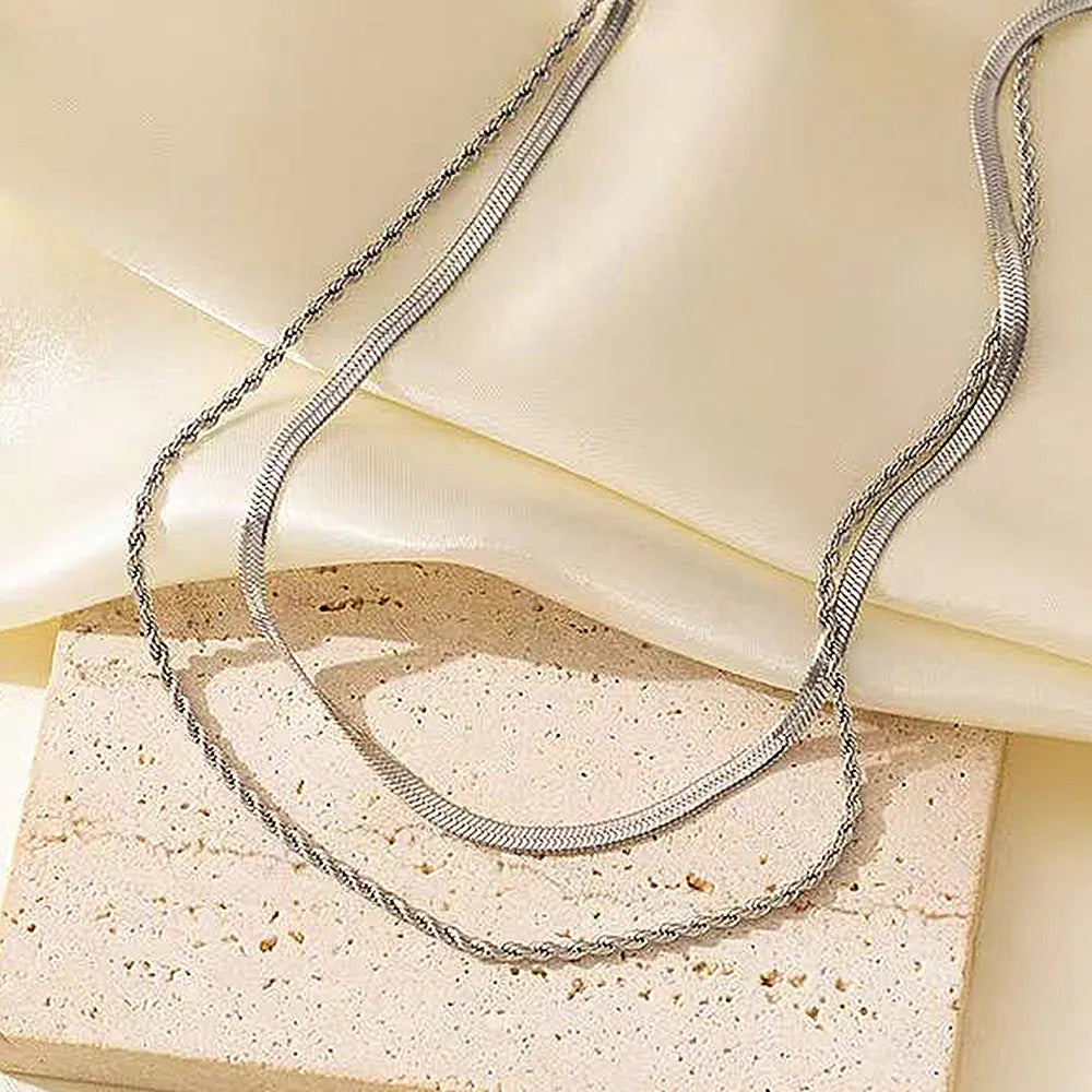 Women's adjustable double-layer twist necklace with titanium steel geometric pendant on snake bones chain, showing 21-50cm length range