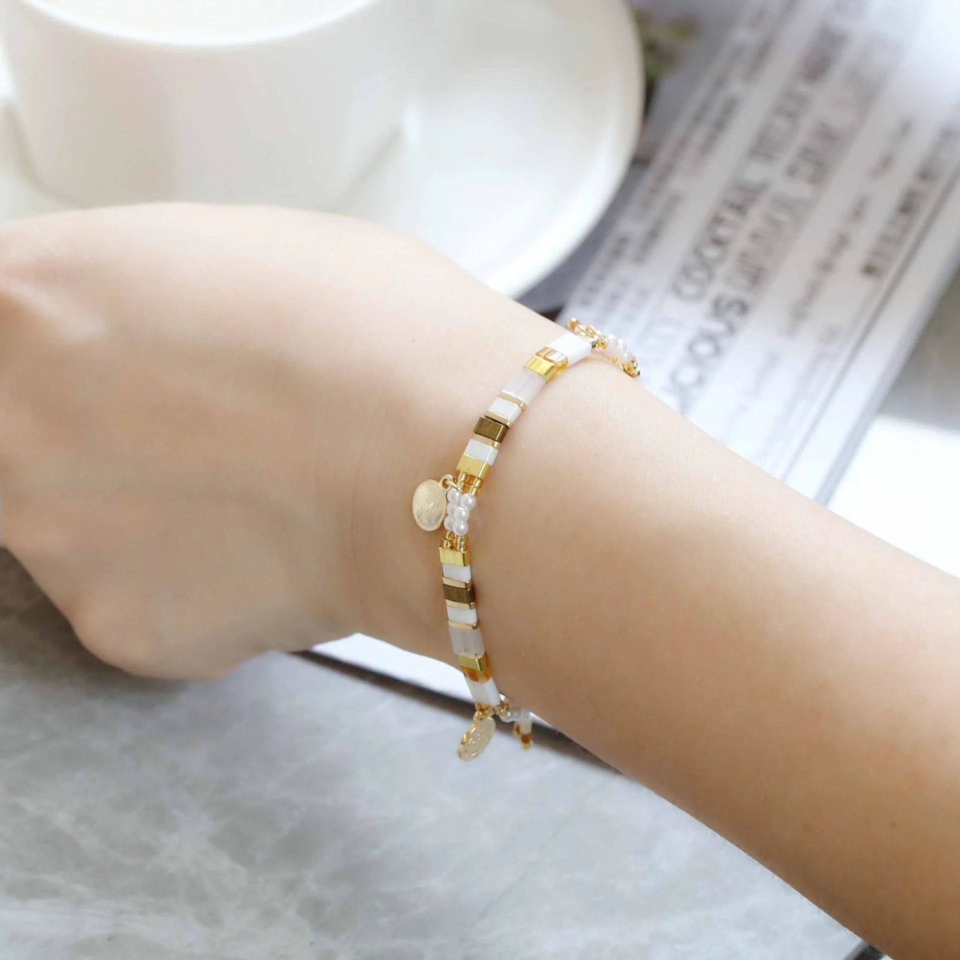 Women's handcrafted bracelet with imitation pearl and coloured glass beads in one of six colour styles.