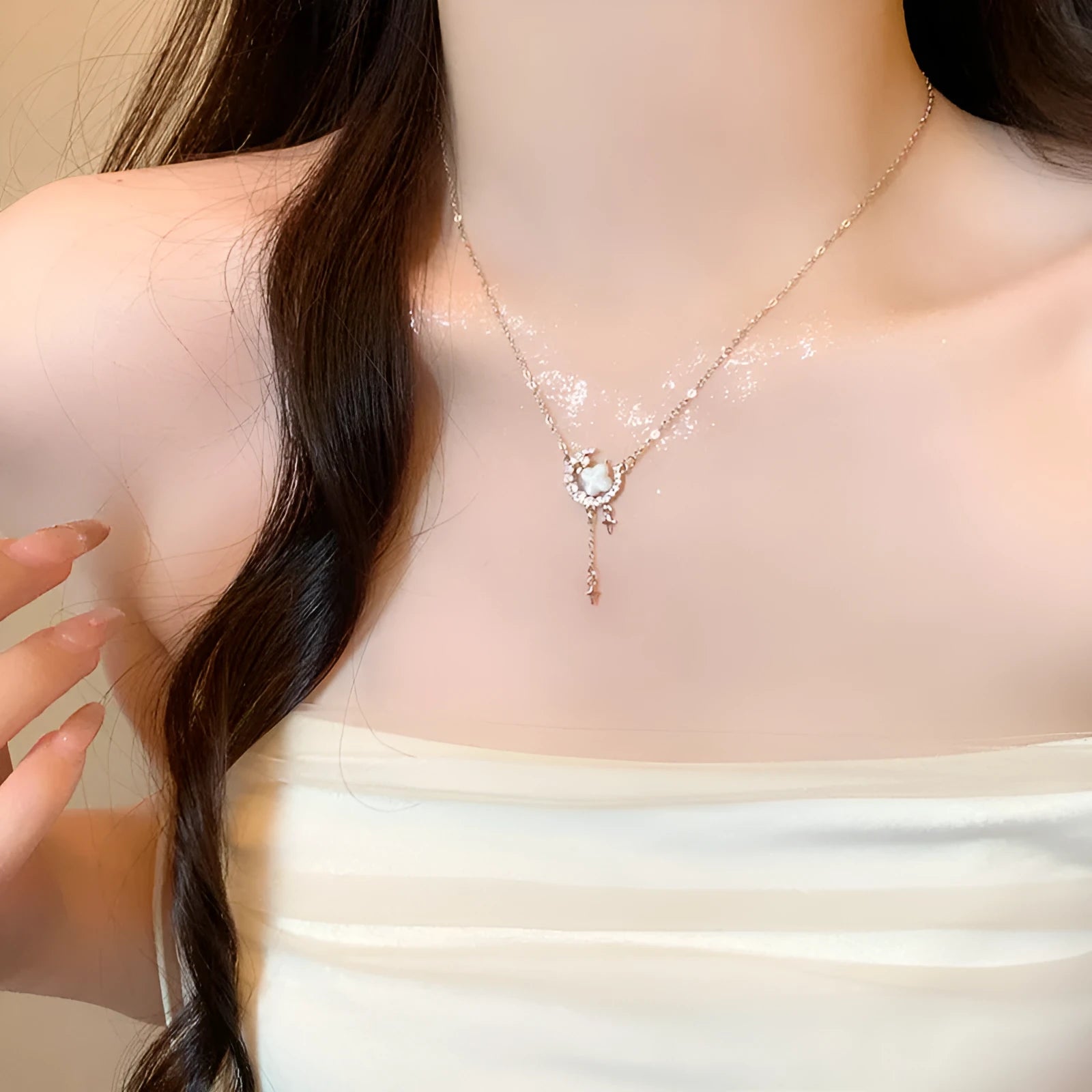 Women's sparking zirconium necklace showing star and moon pendant on adjustable chain