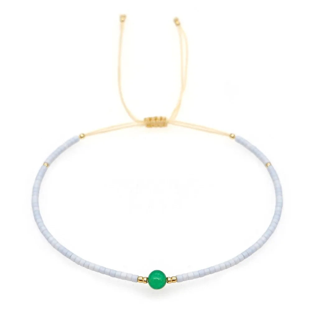 Handmade women's bracelet with colourful geometric glass and coloured glaze beads in Bohemian style.