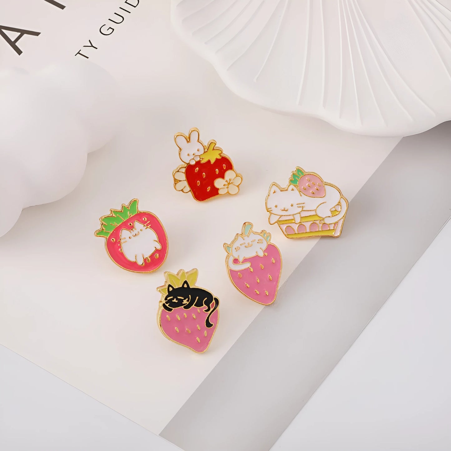 Close-up of a cute cat strawberry and dripping cake oil design metal alloy brooch pin.