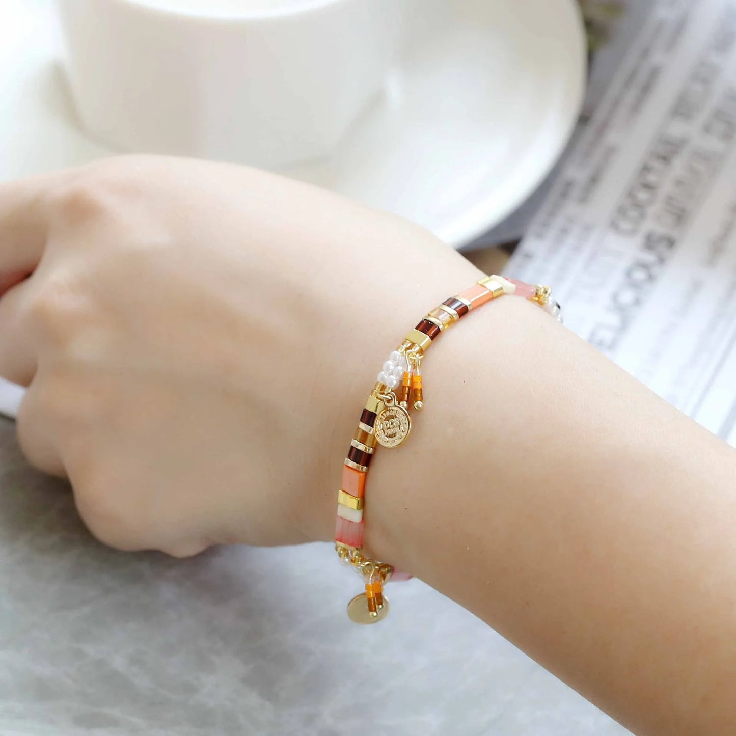 Women's handcrafted bracelet with imitation pearl and coloured glass beads in one of six colour styles.