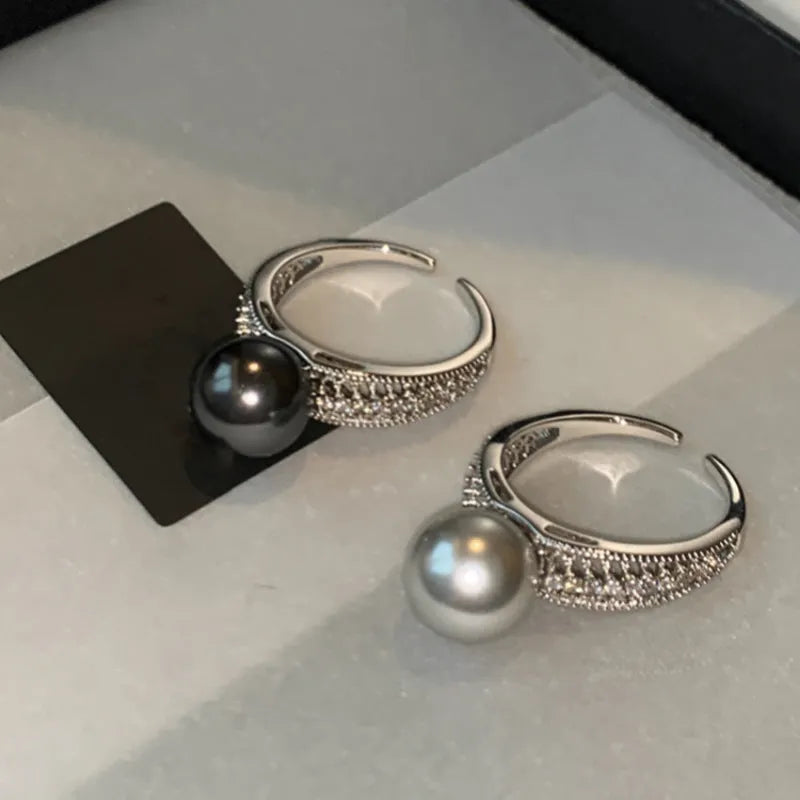 Black Pearl geometric open-ended adjustable copper ring on a woman's finger, showing angular design.