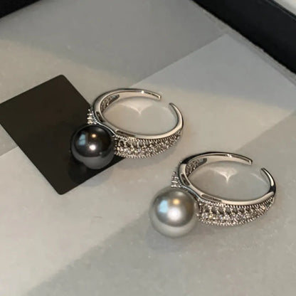 Black Pearl geometric open-ended adjustable copper ring on a woman's finger, showing angular design.