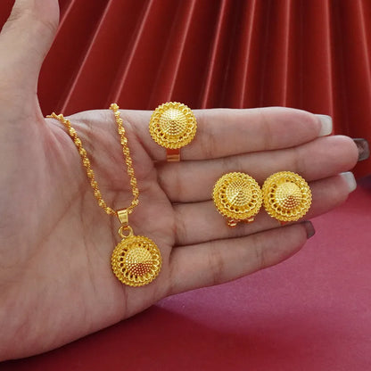 Gold-plated three-piece jewellery set with a three-layer flower design necklace, matching earrings, and ring on a white background.