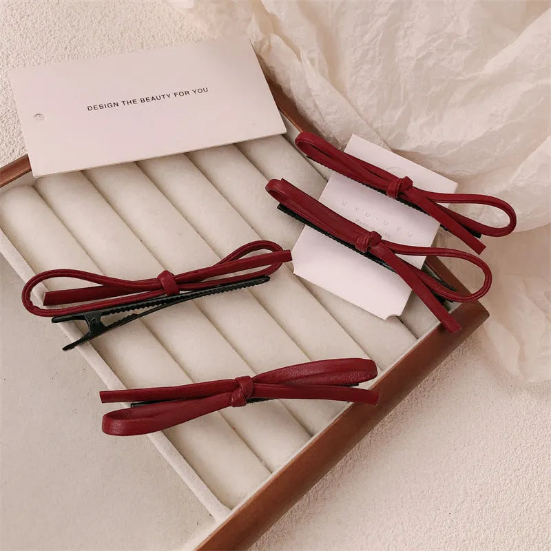 Wine red leather bow hair barrette with 2.5cm bow width and 5cm clip length