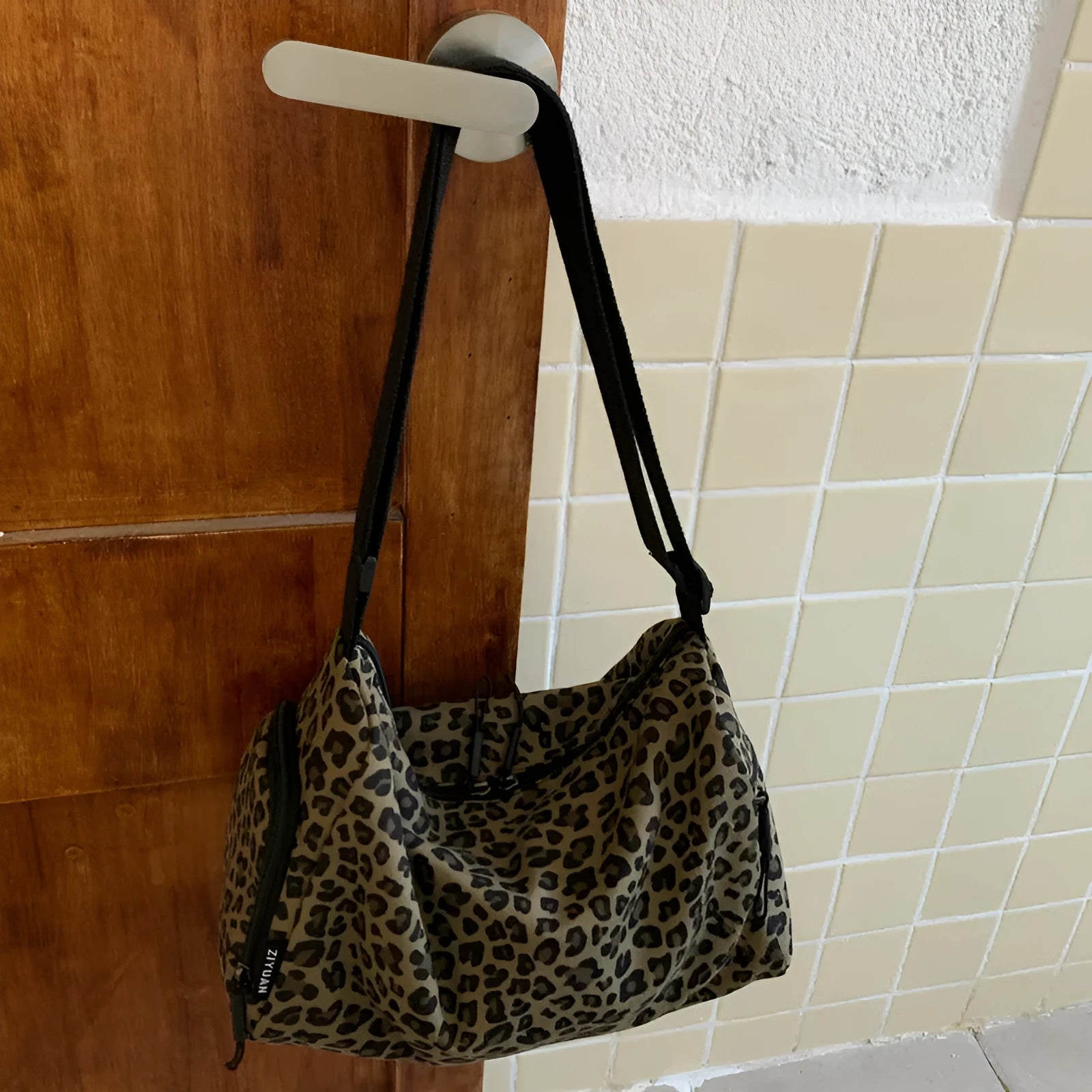 Leopard print sports style shoulder messenger bag with visible stitching and cross-body strap
