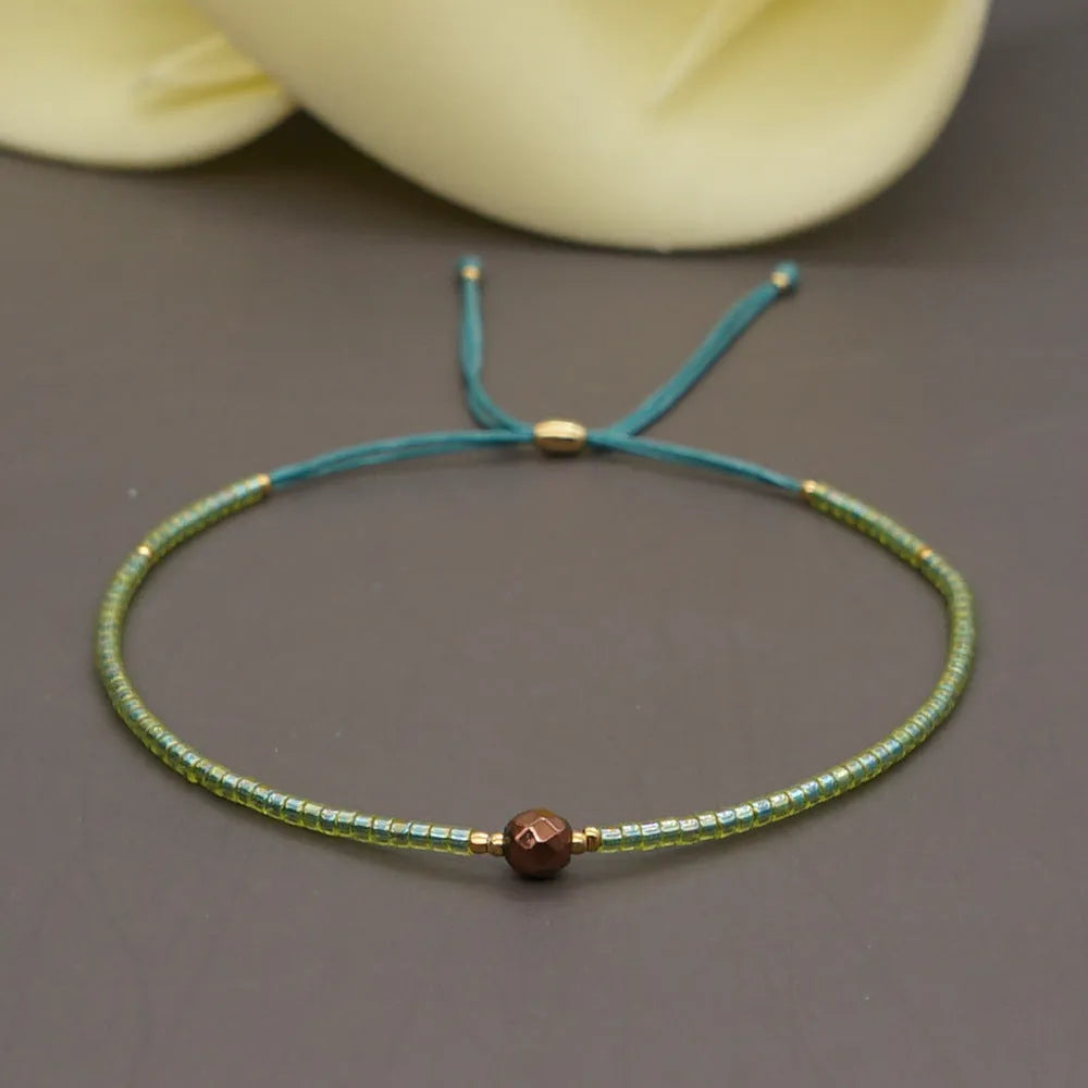 Handmade women's bracelet with colourful geometric glass and coloured glaze beads in Bohemian style.