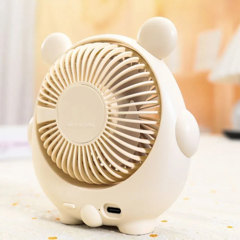USB desktop fan with dog design showing three speed buttons and USB port, placed on a desk.