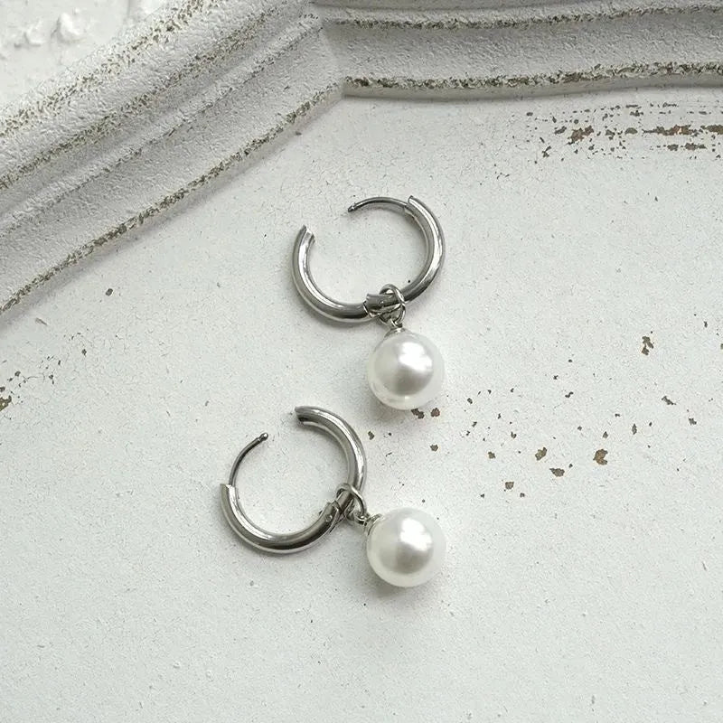 Geometric round pearl drop earrings for women with alloy metal and titanium steel posts.
