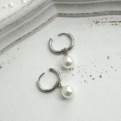 Geometric round pearl drop earrings for women with alloy metal and titanium steel posts.