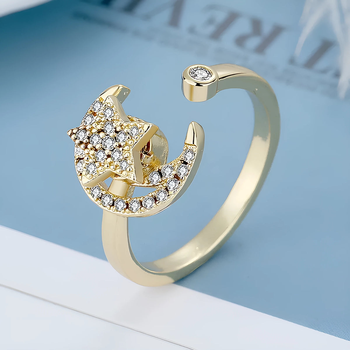 Adjustable copper ring with micro-inlaid zircon stars and rotating moon element in geometric design