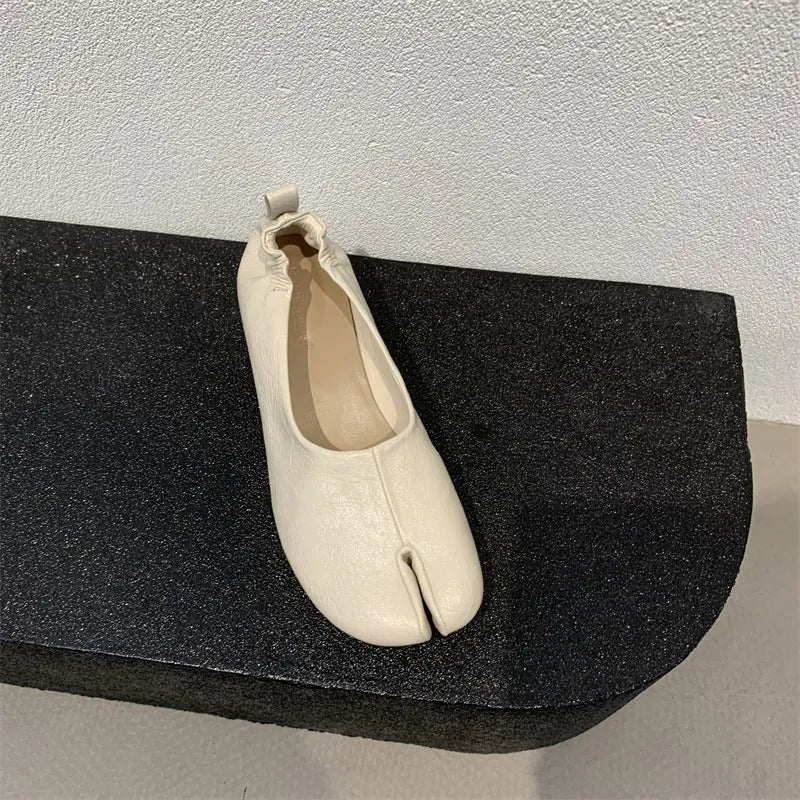 Women's black split-toe chunky heel pumps with round toe and low heel on a white background