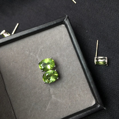 Close-up of grass green natural olivine stud earrings with geometric cut on S925 silver posts