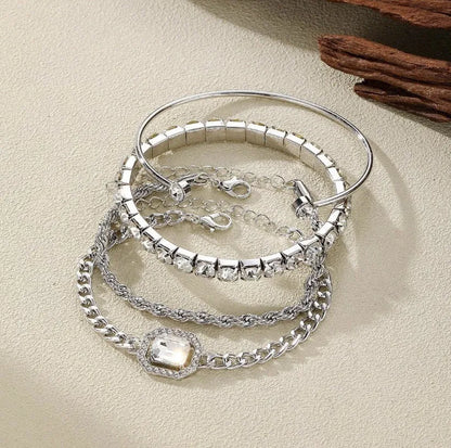 Women's four-piece alloy jewellery set with geometric square diamond shapes and chain links in gold finish