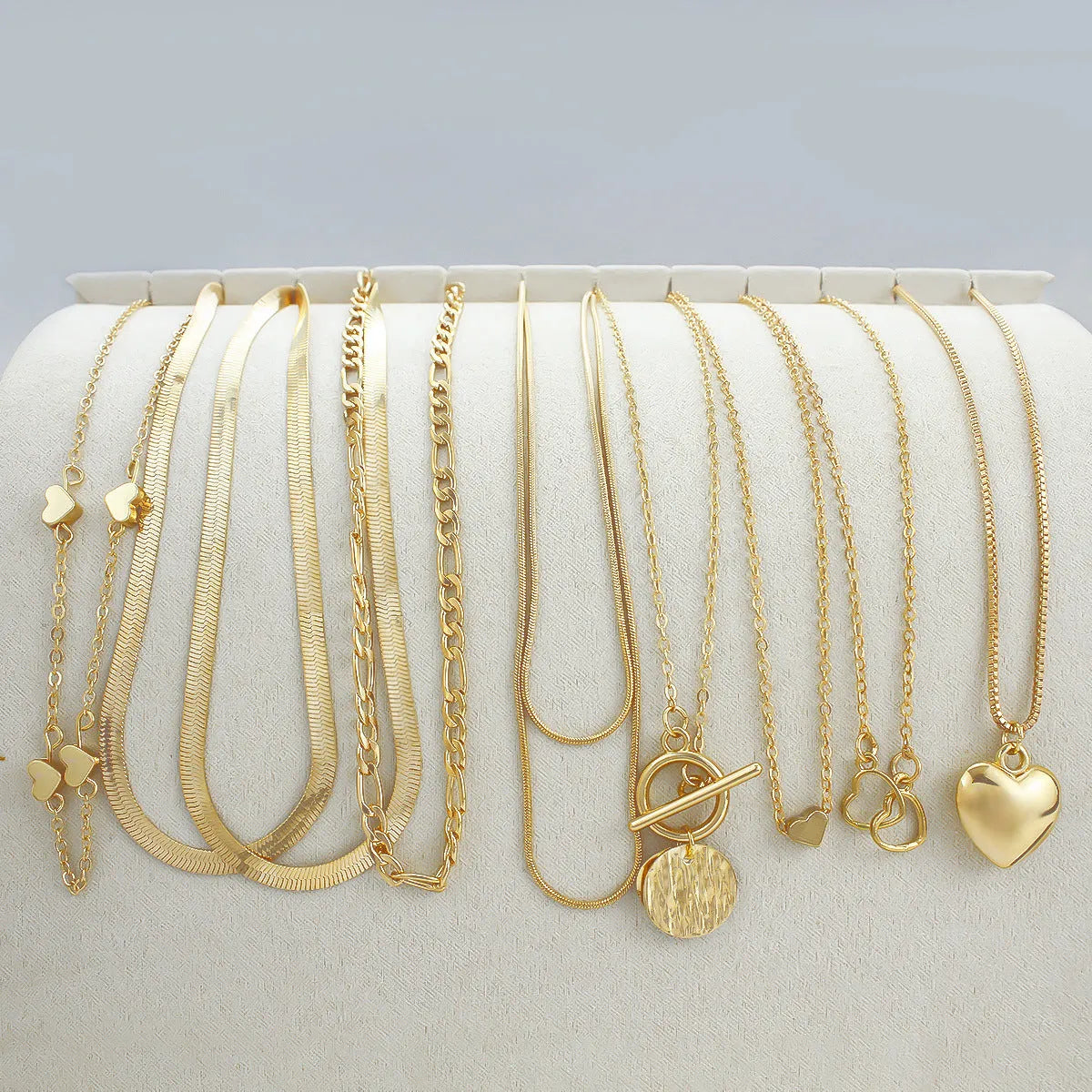 10 gold necklaces with adjustable chains from 21cm to 50cm, featuring electroplated alloy pendants on snake bone chains