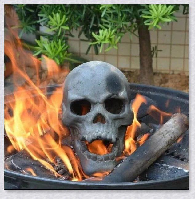 Terrifying human skull fire pit with flames escaping from the eyes and nose, perfect for outdoor gatherings and Halloween celebrations