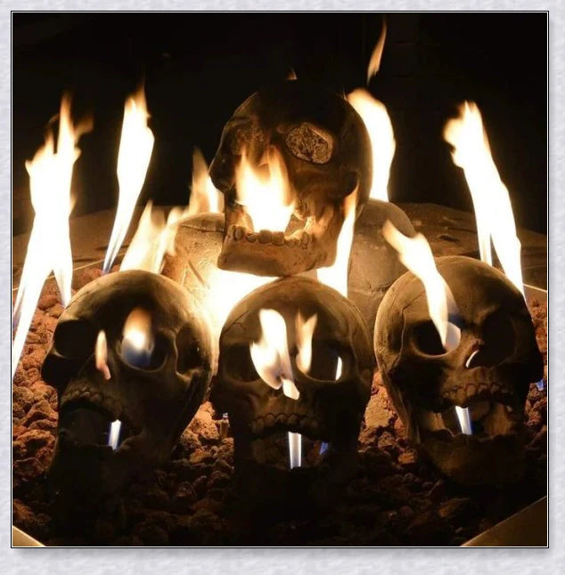 Terrifying human skull fire pit with flames escaping from the eyes and nose, perfect for outdoor gatherings and Halloween celebrations