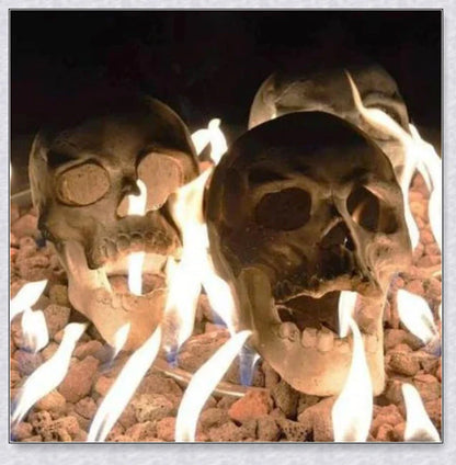 Terrifying human skull fire pit with flames escaping from the eyes and nose, perfect for outdoor gatherings and Halloween celebrations