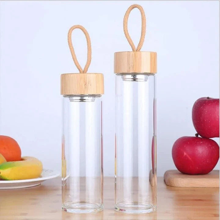 Elegant glass water bottle with bamboo lid and string, a sustainable and fashionable hydration solution