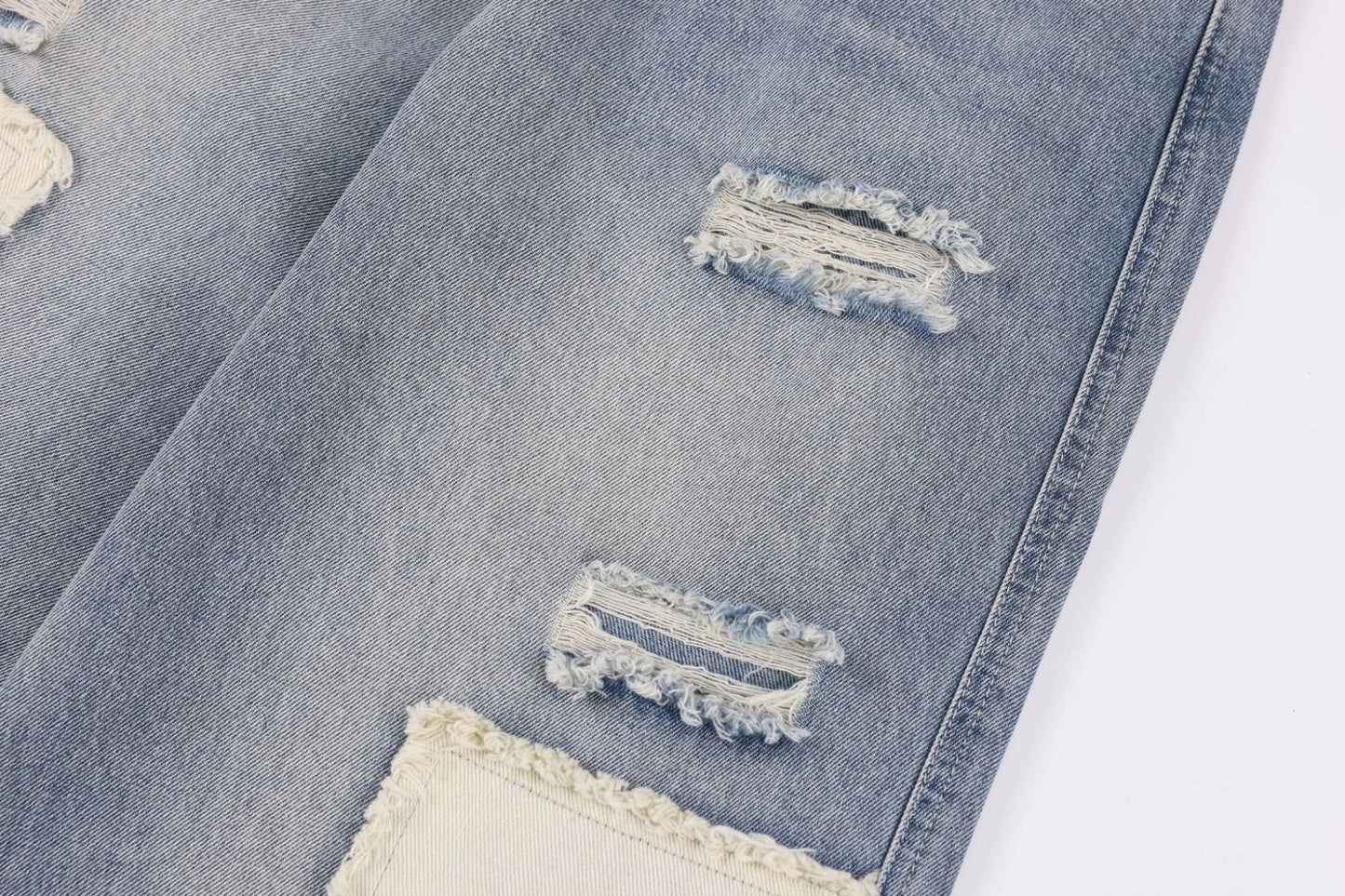 A pair of premium American-style distressed jeans with a straight-leg design and heavy-duty denim construction