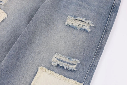 A pair of premium American-style distressed jeans with a straight-leg design and heavy-duty denim construction