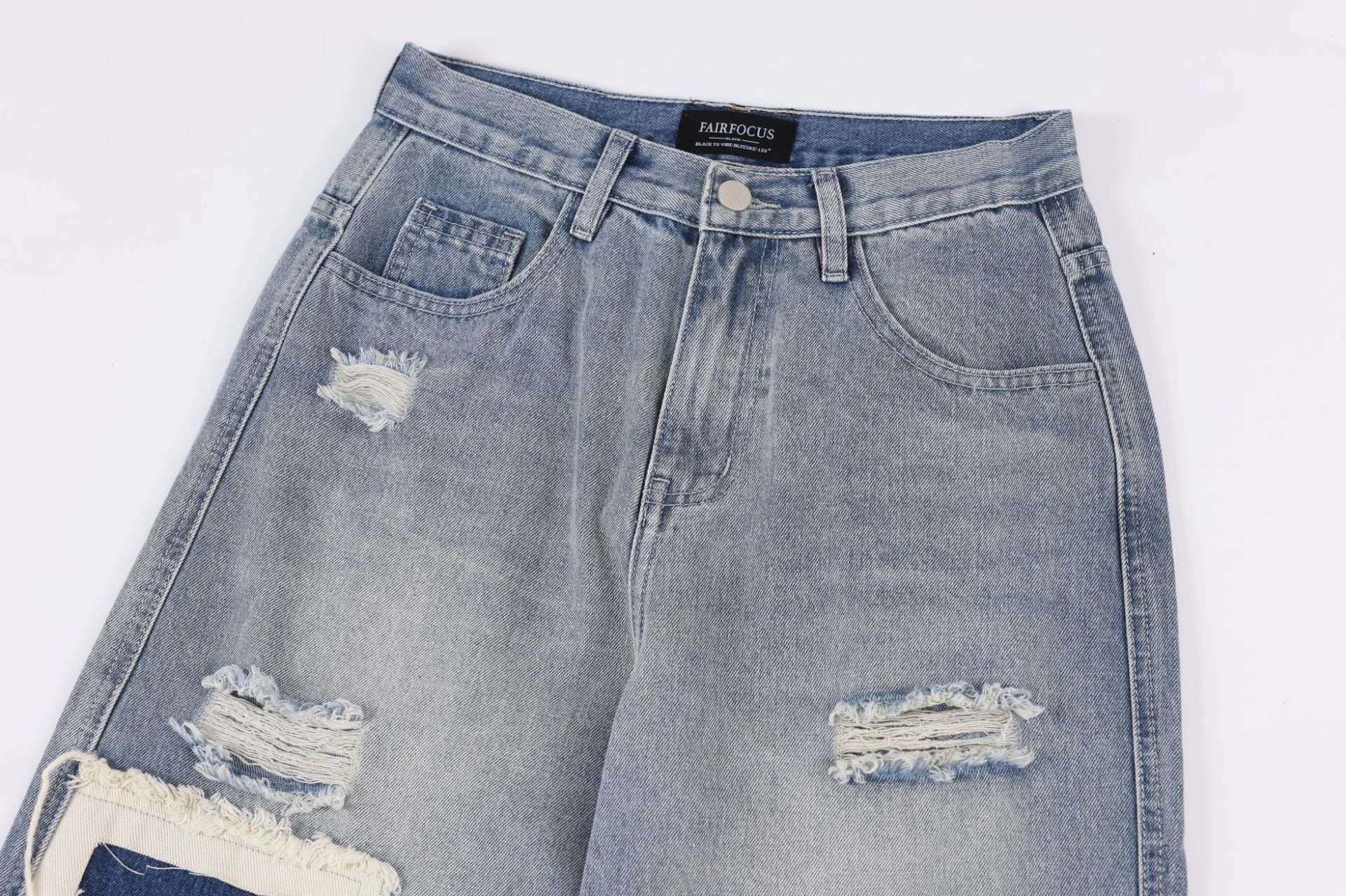 A pair of premium American-style distressed jeans with a straight-leg design and heavy-duty denim construction