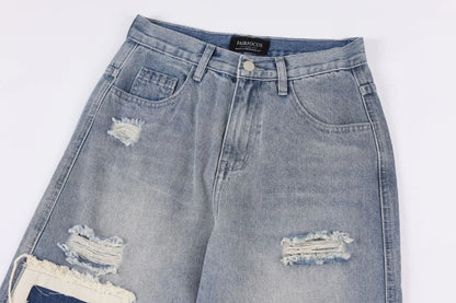 A pair of premium American-style distressed jeans with a straight-leg design and heavy-duty denim construction