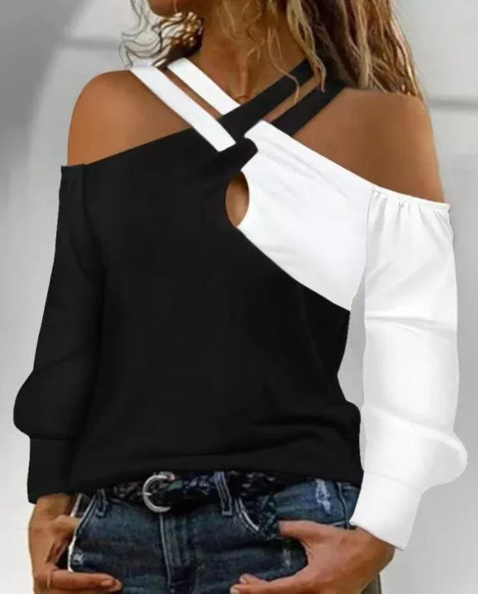 A stylish women's top with a black and white patchwork design, featuring a cross-belt accent for a fashionable casual look.